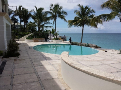 Pool coping and tiles with silver travertine accent strips.
